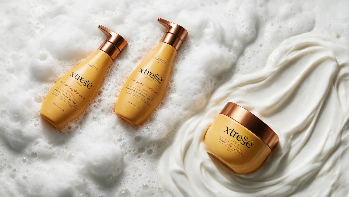 Xtressé Volumizing Shampoo, Volumizing Conditioner and Deep Moisturizing Hair Mask resting in rich lather and mask cream.