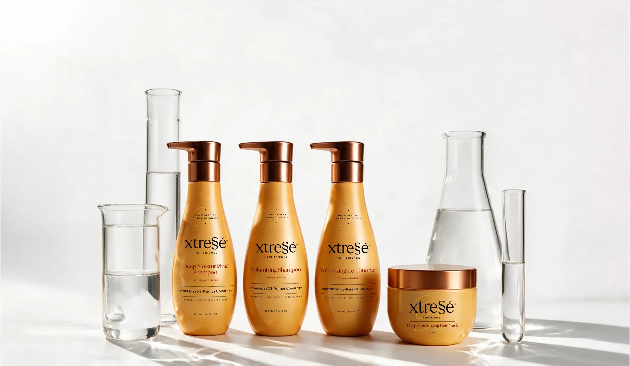 Xtressé Hair Science shampoo, conditioner and hair mask with laboratory glassware